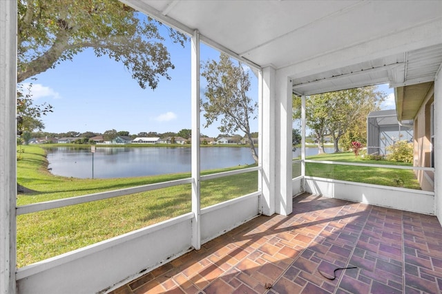 unfurnished sunroom with a water view