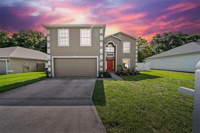 view of front property featuring a yard and a garage