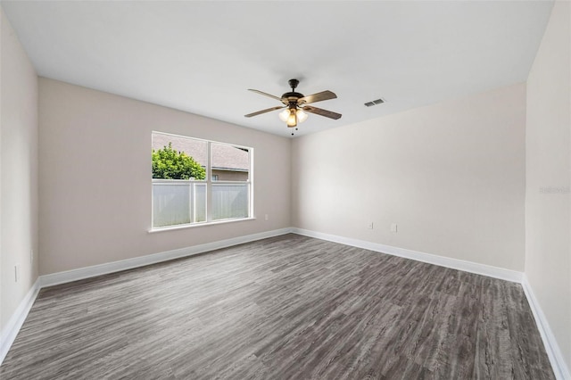 unfurnished room featuring dark hardwood / wood-style floors and ceiling fan