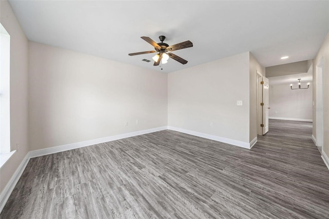 spare room with ceiling fan and dark wood-type flooring