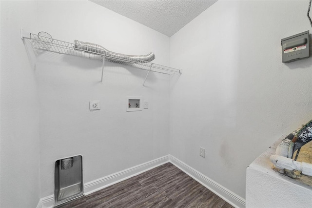 laundry area featuring washer hookup, a textured ceiling, and dark wood-type flooring