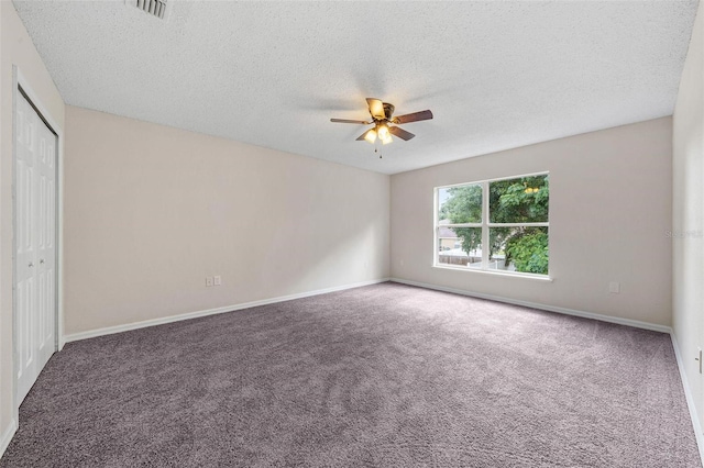 unfurnished bedroom featuring carpet flooring, ceiling fan, and a textured ceiling