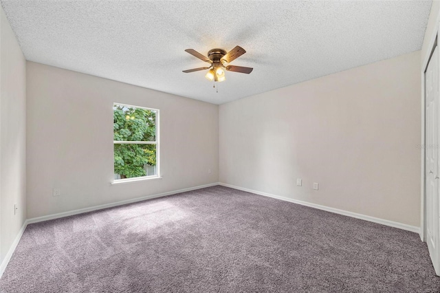 carpeted empty room with ceiling fan and a textured ceiling