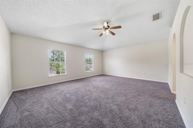 carpeted spare room with ceiling fan and a textured ceiling