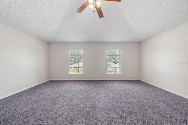 empty room with ceiling fan, carpet, and a textured ceiling