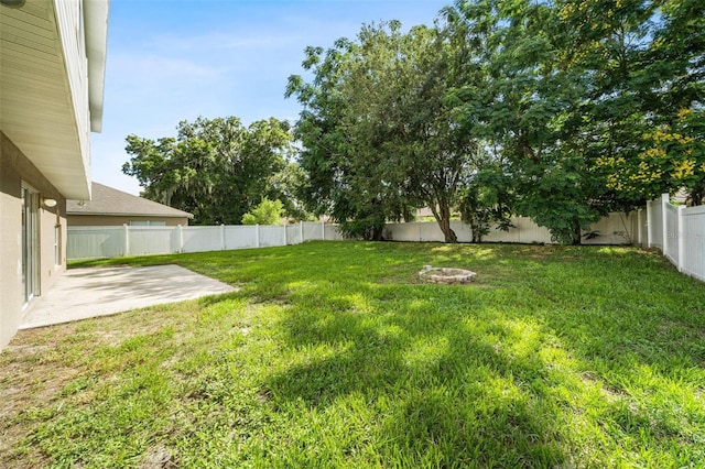 view of yard with a patio and a fire pit