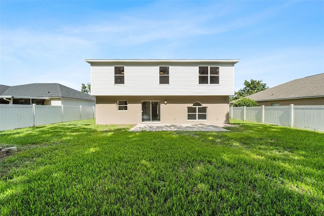 back of house with a patio and a lawn