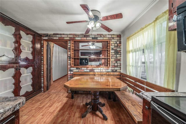 interior space featuring ceiling fan, ornamental molding, and light hardwood / wood-style flooring