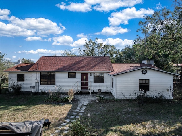 view of front of home with a patio area and a front lawn