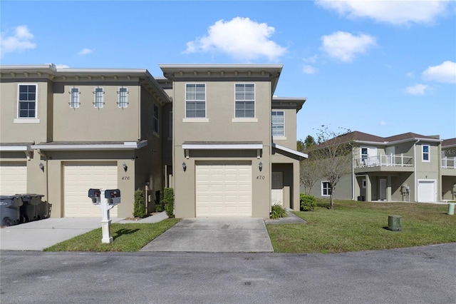 multi unit property featuring a garage and a front lawn