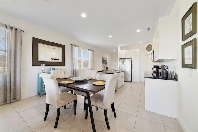 dining room with light tile patterned floors and sink