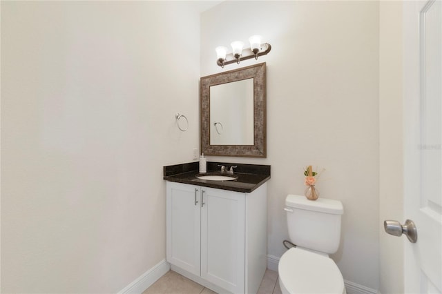 bathroom featuring tile patterned flooring, vanity, and toilet