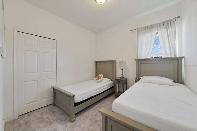 carpeted bedroom featuring a closet