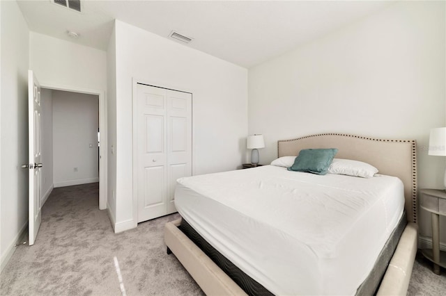 bedroom featuring light carpet and a closet