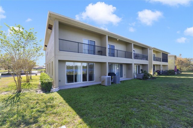 470 Lake Shore Pkwy, Davenport, FL 33896 - back of property featuring stucco siding, central AC unit, and a yard