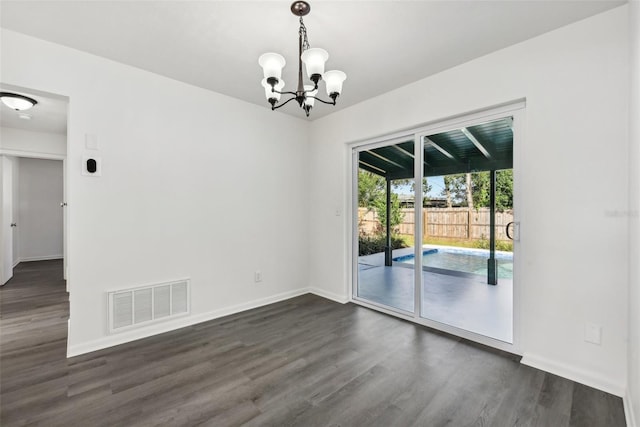 unfurnished dining area featuring dark hardwood / wood-style floors and a notable chandelier