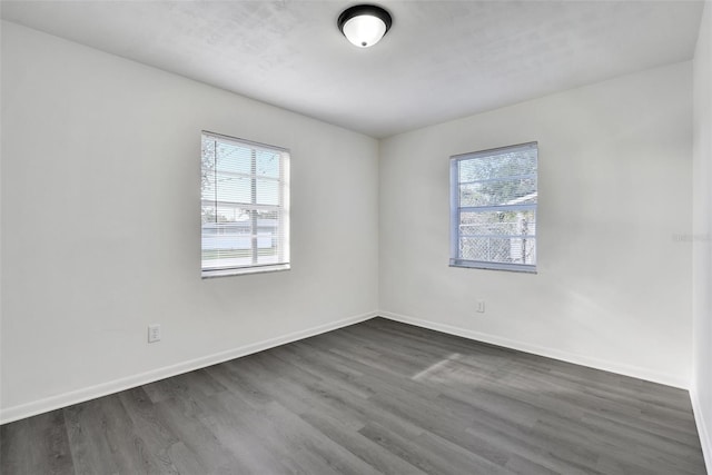 spare room with dark hardwood / wood-style flooring