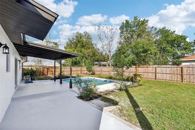 view of pool featuring a lawn and a patio