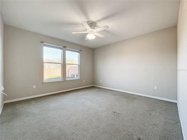 spare room with carpet flooring, a ceiling fan, baseboards, and a textured ceiling