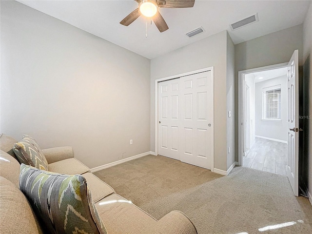 living area featuring ceiling fan and light carpet