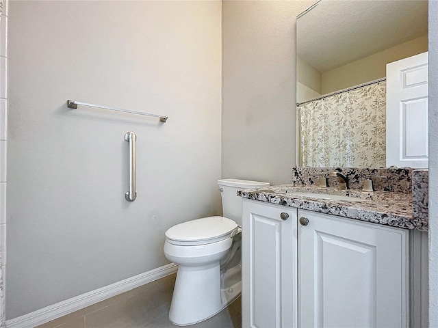 bathroom featuring vanity, toilet, and a textured ceiling