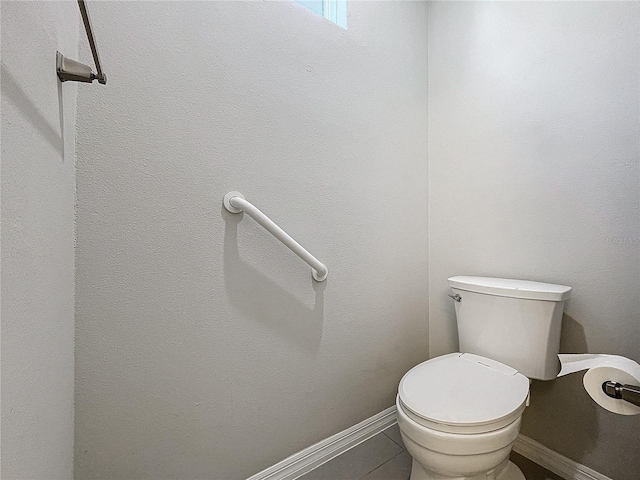 bathroom featuring toilet and tile patterned floors