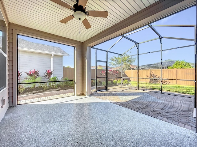 unfurnished sunroom with ceiling fan, wood ceiling, and lofted ceiling