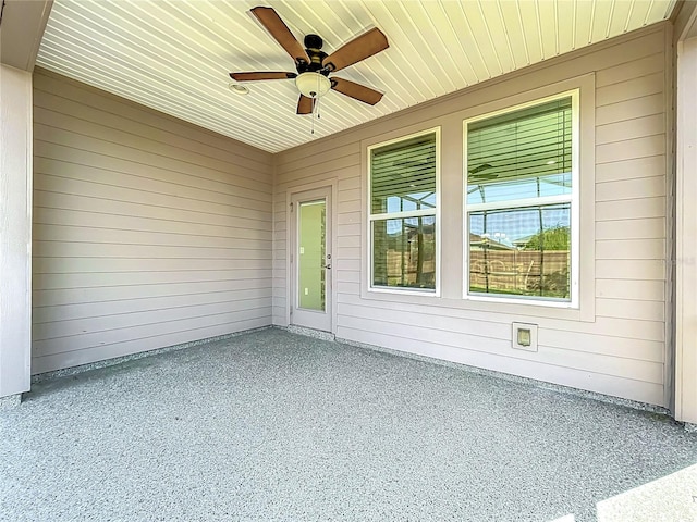 unfurnished sunroom featuring ceiling fan and wood ceiling