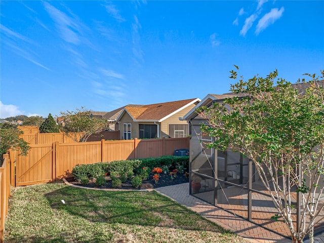 view of yard with a sunroom and fence