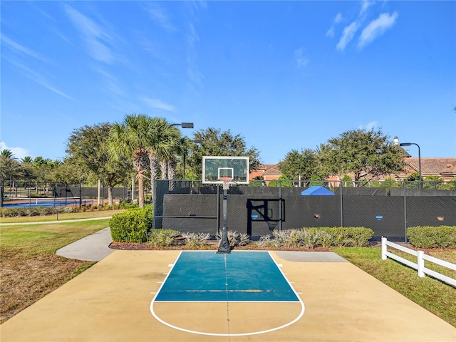 view of basketball court with community basketball court and fence