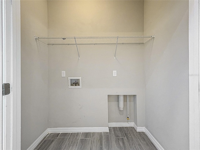 washroom with baseboards, gas dryer hookup, wood tiled floor, laundry area, and washer hookup