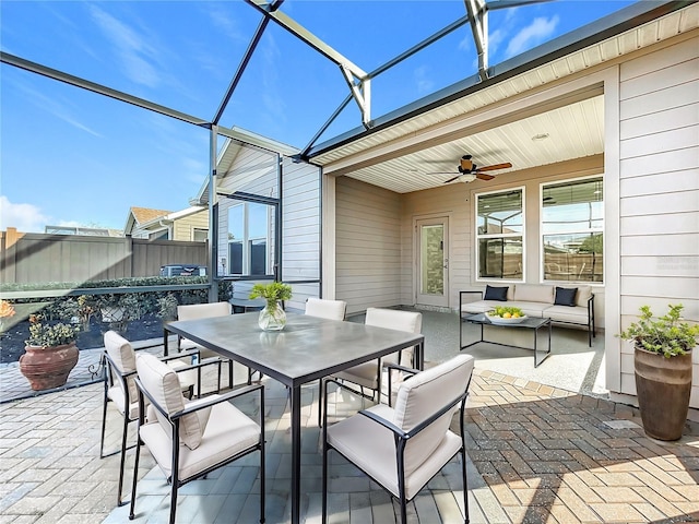 sunroom with a healthy amount of sunlight and a ceiling fan