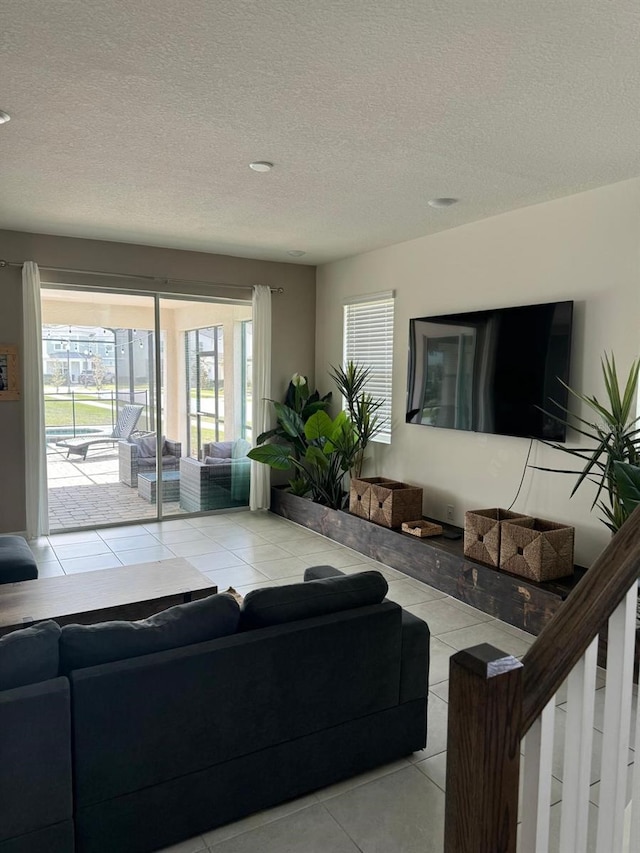 tiled living room featuring a textured ceiling