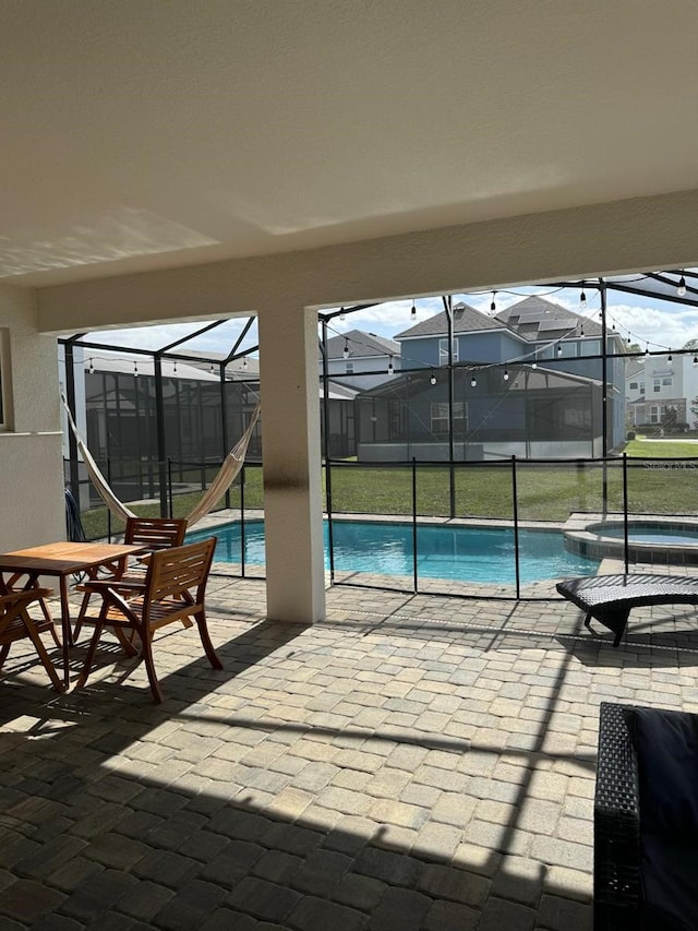 view of pool featuring a lanai, a yard, and a patio