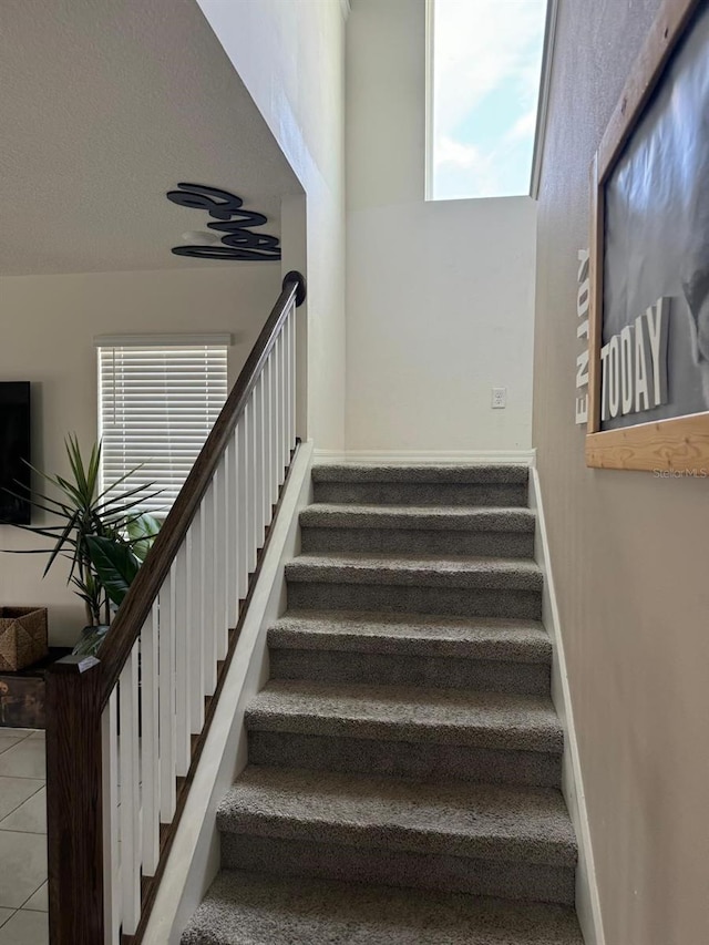 staircase with tile patterned floors