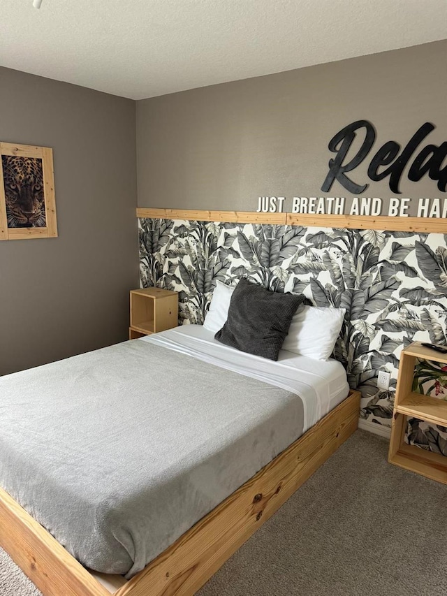 bedroom with carpet and a textured ceiling