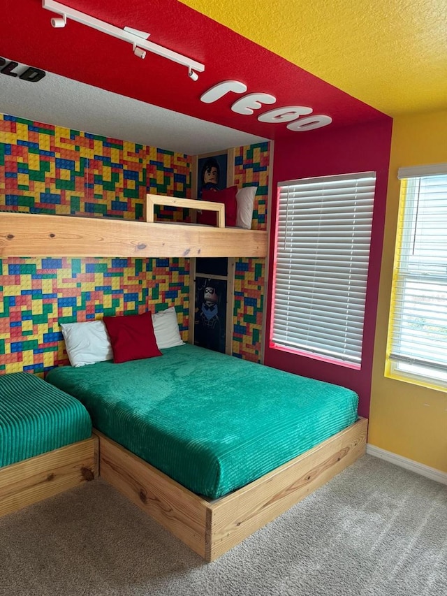 carpeted bedroom featuring a textured ceiling