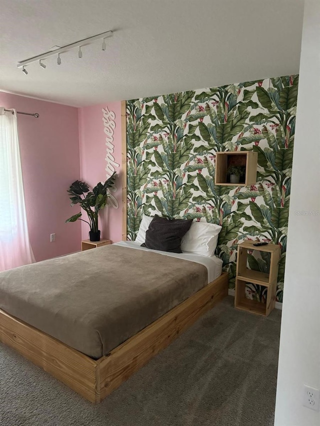 bedroom with carpet flooring and rail lighting