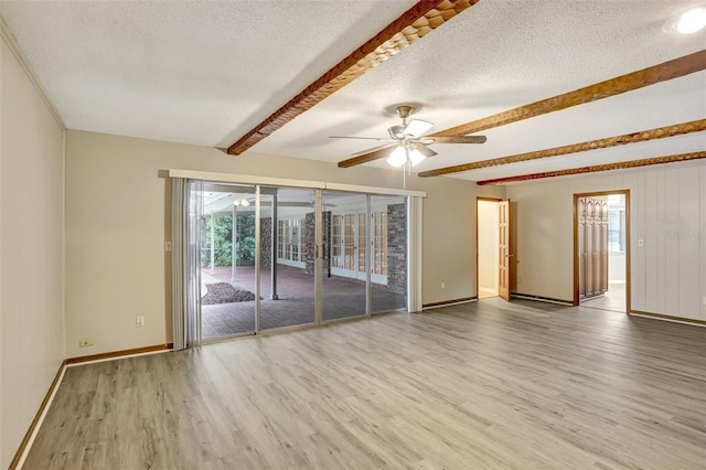 unfurnished room featuring beamed ceiling, wood-type flooring, a textured ceiling, and ceiling fan