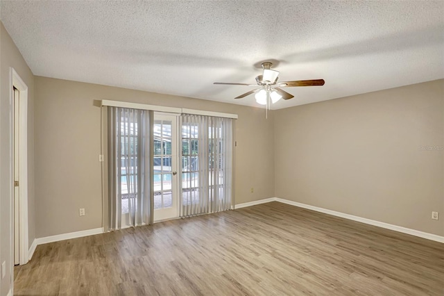 spare room with ceiling fan, wood-type flooring, and a textured ceiling