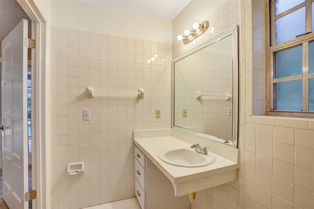 bathroom featuring tile walls and sink