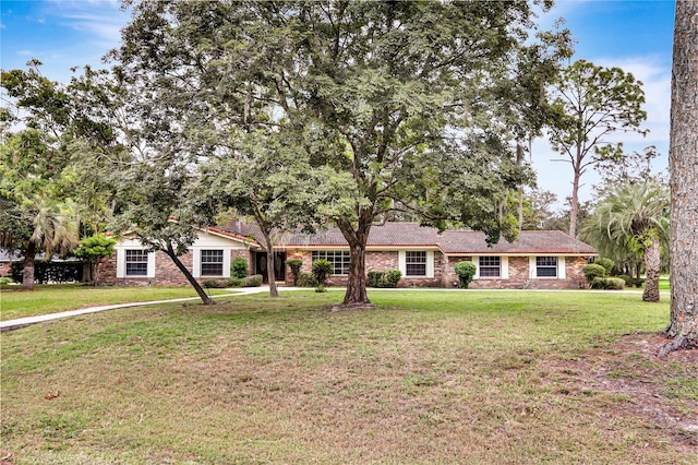 ranch-style home with a front yard