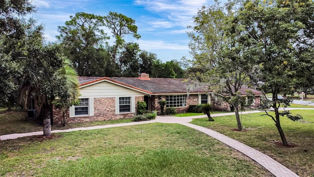 ranch-style home featuring a front yard