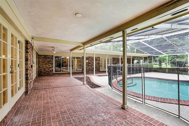 view of pool featuring a lanai, a patio area, and french doors