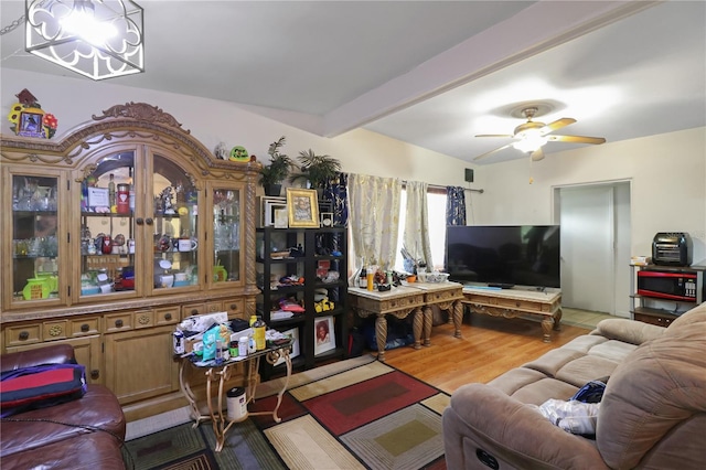 living room with beam ceiling, ceiling fan, and light hardwood / wood-style flooring