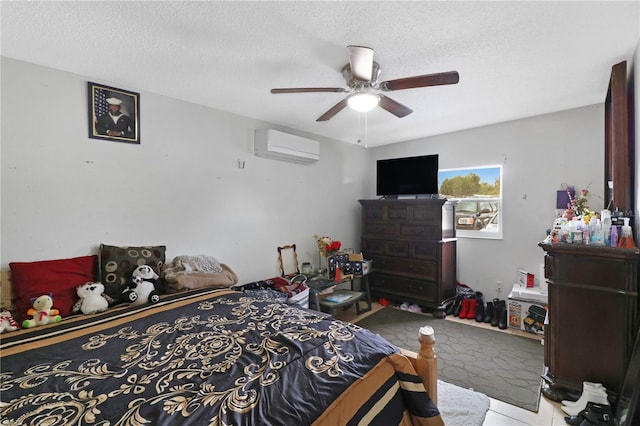 bedroom featuring a wall mounted AC, a textured ceiling, and ceiling fan