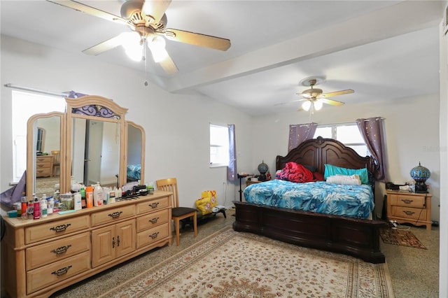 carpeted bedroom featuring ceiling fan, lofted ceiling with beams, and multiple windows