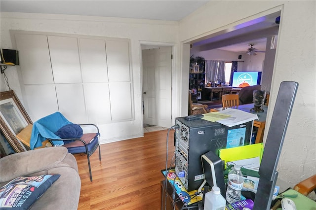 sitting room featuring light hardwood / wood-style flooring and ceiling fan