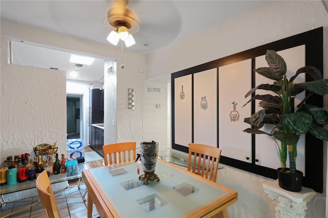 dining area featuring ceiling fan and light tile patterned floors