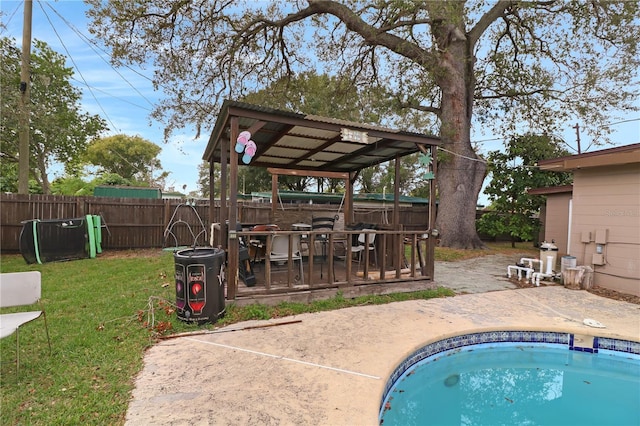 view of pool with a yard, a patio area, and a wooden deck